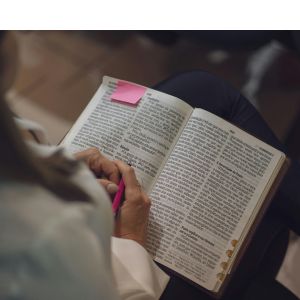 Bible with post it note